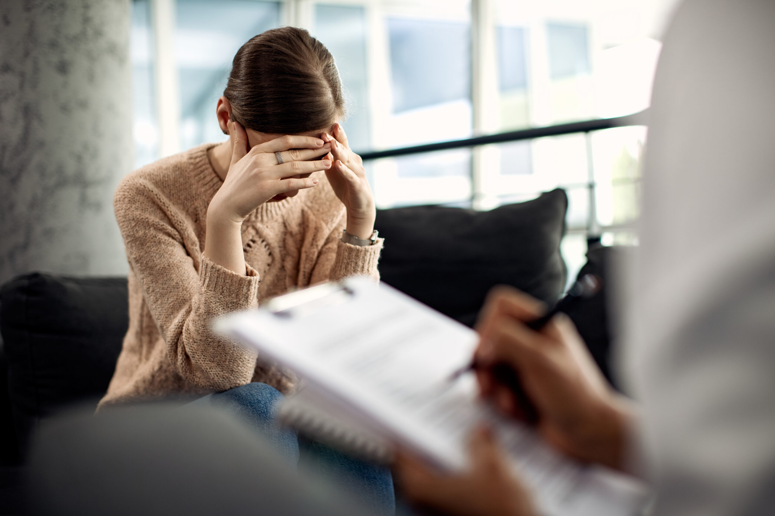Depressed woman having psychotherapy session at doctor’s office. Depressed woman having psychotherapy session at doctor’s office.