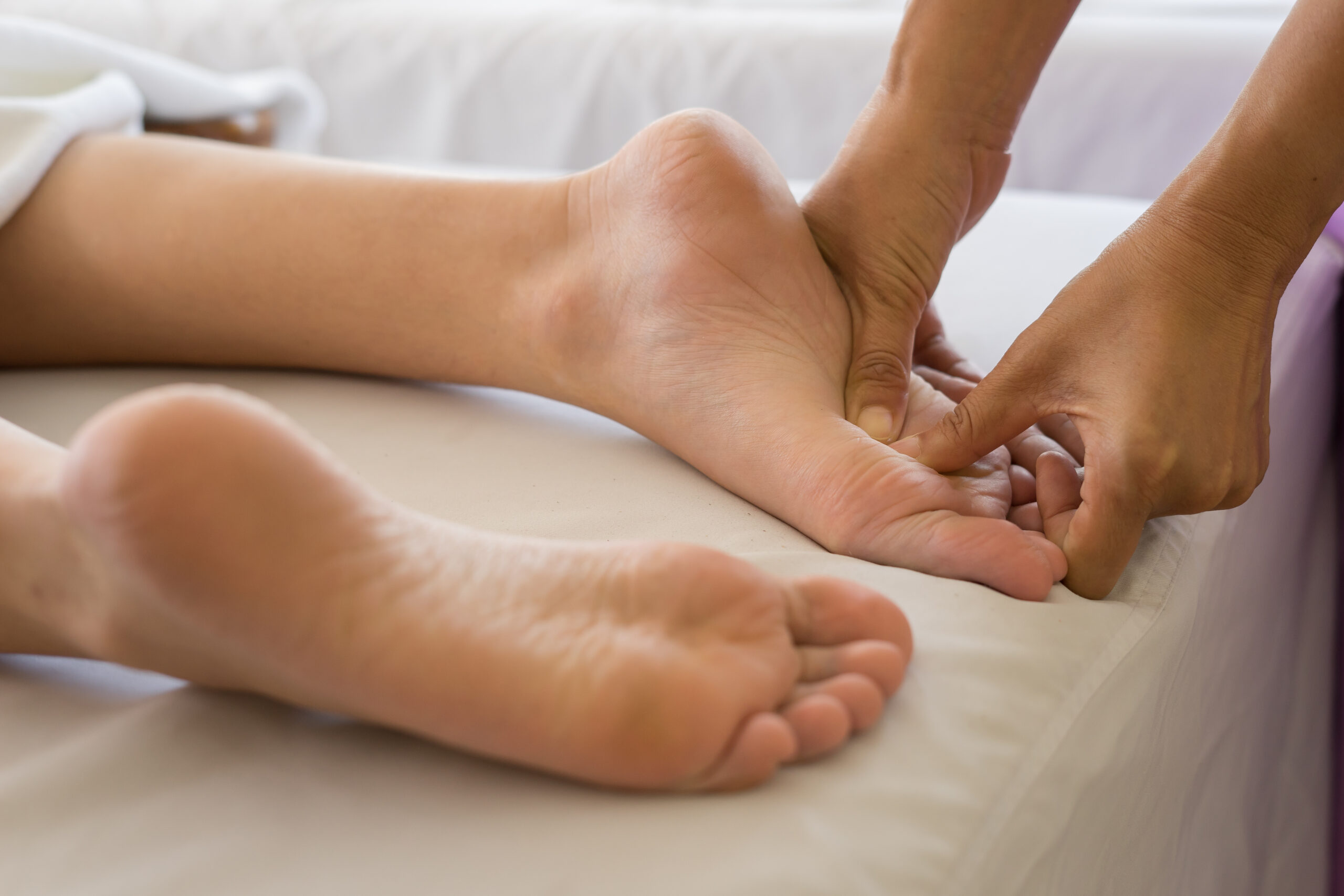 Close-up of woman doing foot massage at spa. Close-up of woman doing foot massage at spa.