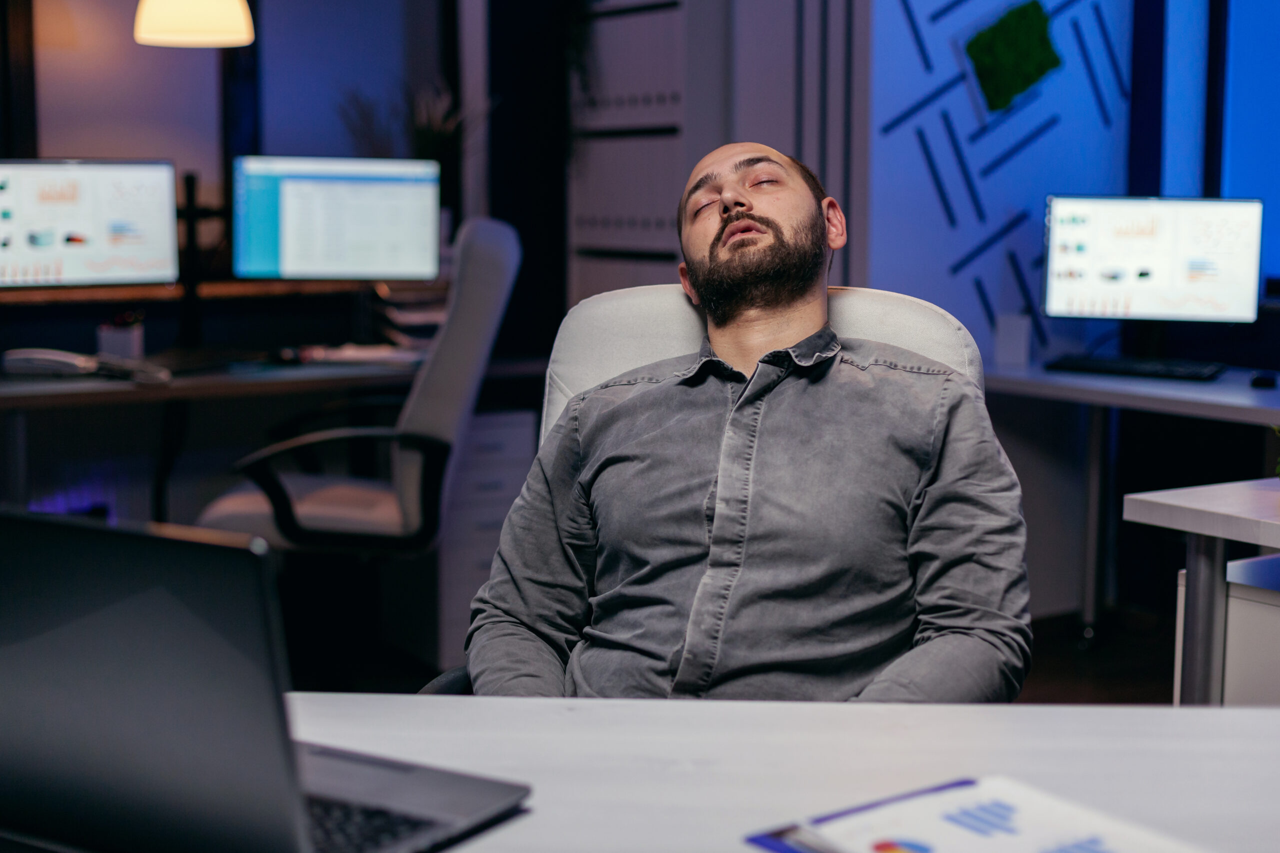 Overworked exhausted man sleeps on chair Overworked exhausted man sleeps on chair