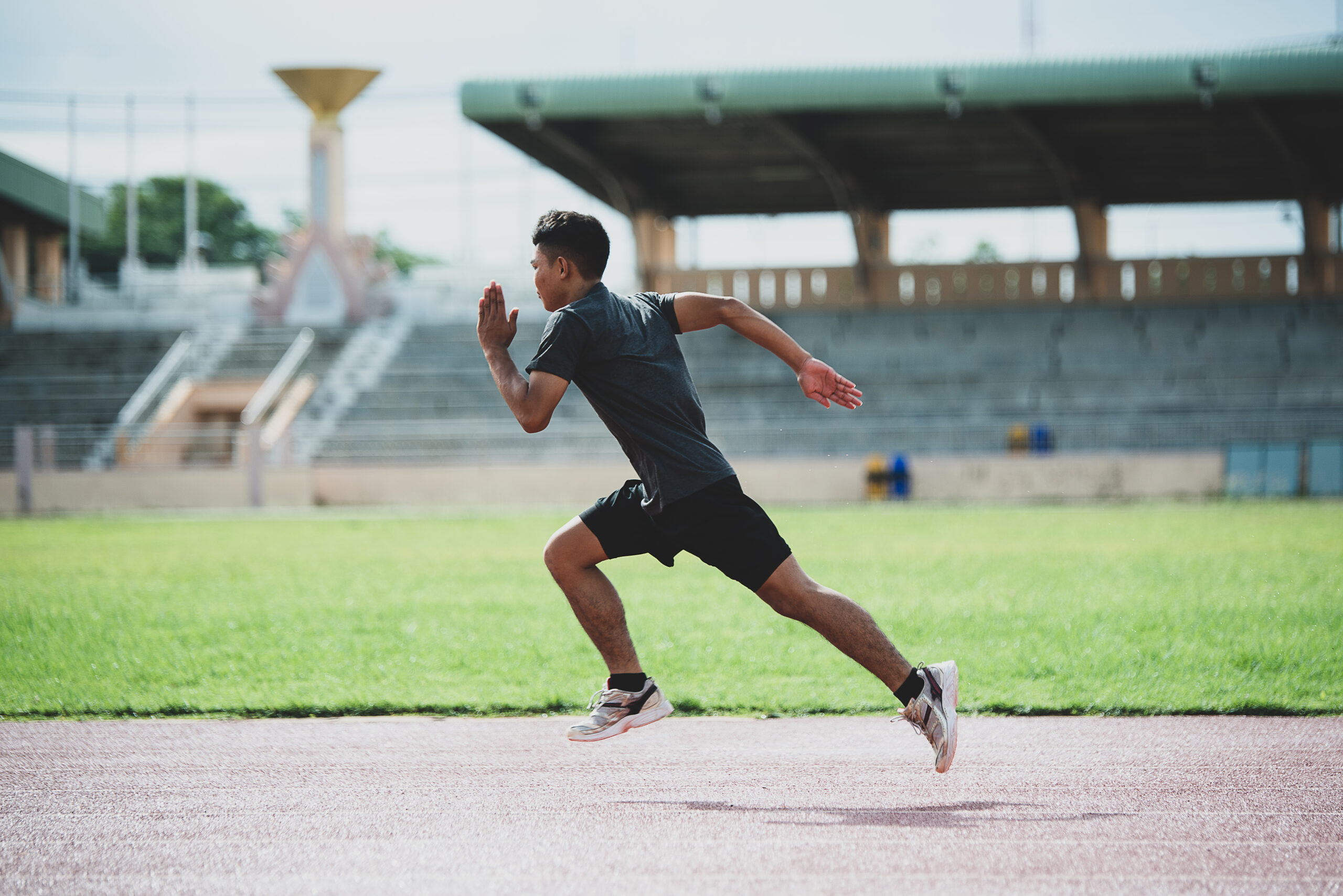 athlete standing on an all-weather running track athlete standing on an all-weather running track