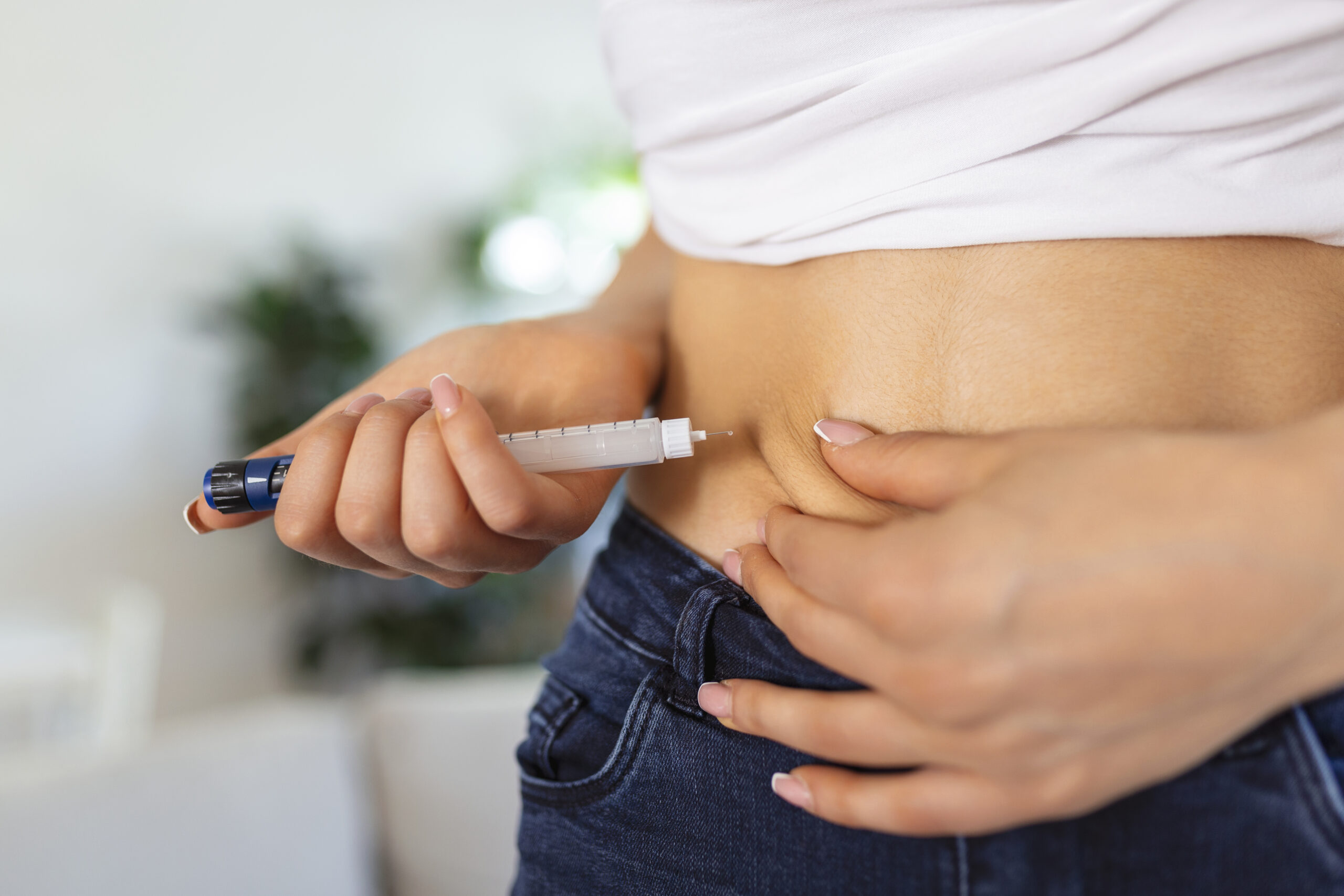 A diabetic patient using insulin pen for making an insulin injection at home. Young woman control diabetes. Diabetic lifestyle A diabetic patient using insulin pen for making an insulin injection at home. Young woman control diabetes. Diabetic lifestyle
