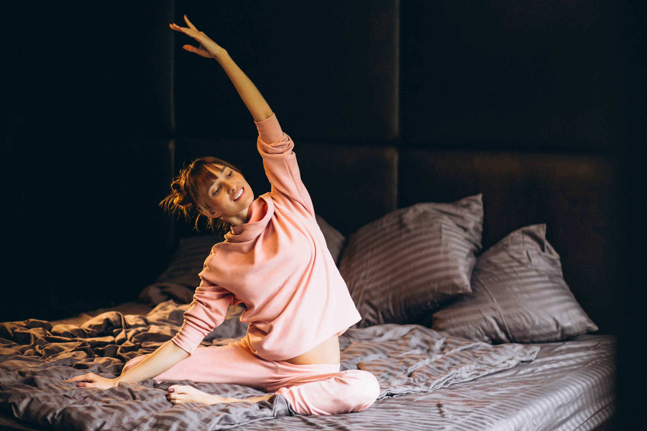 Woman doing yoga in bed Woman doing yoga in bed