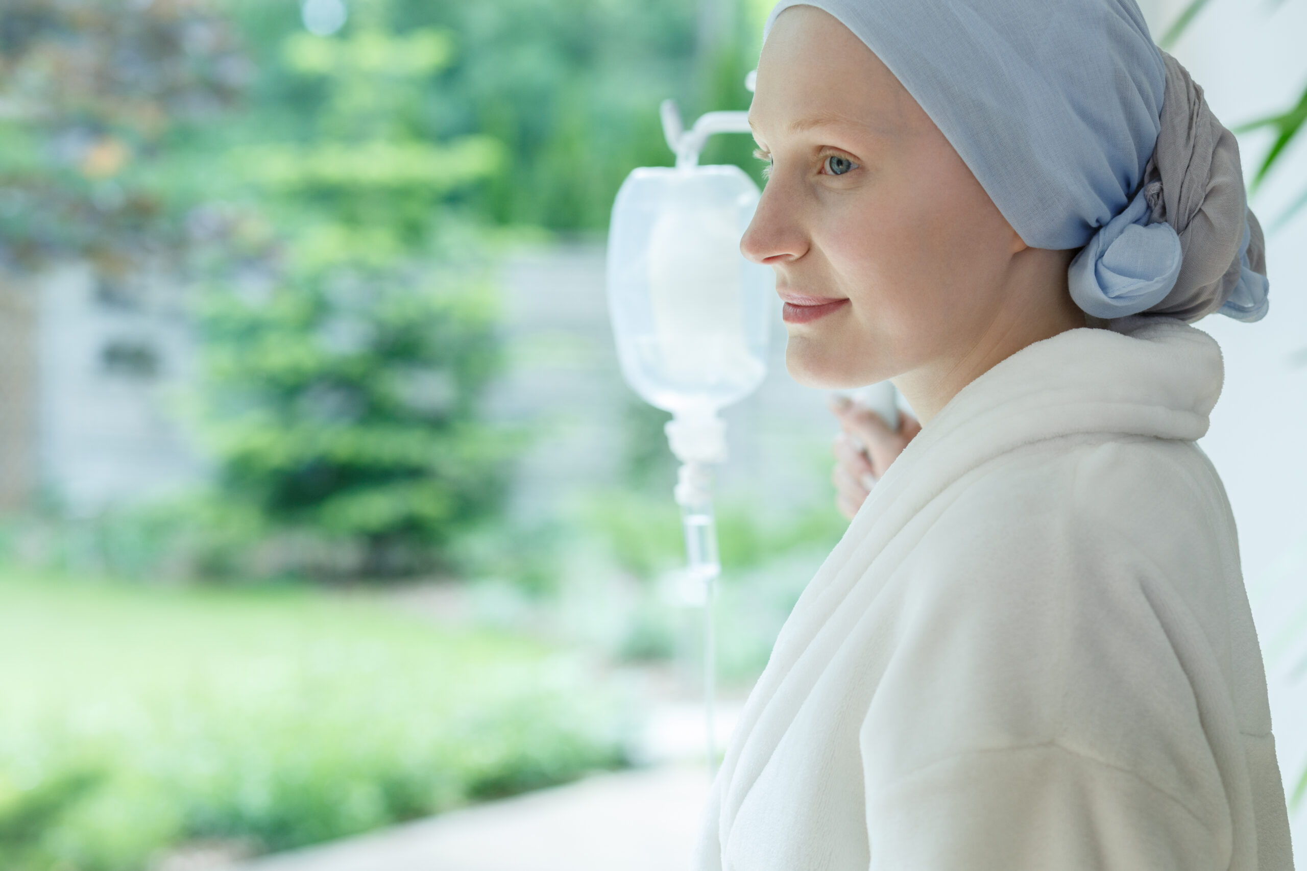 Woman,In,White,Robe,Smiling,And,Looking,Out,The,Window