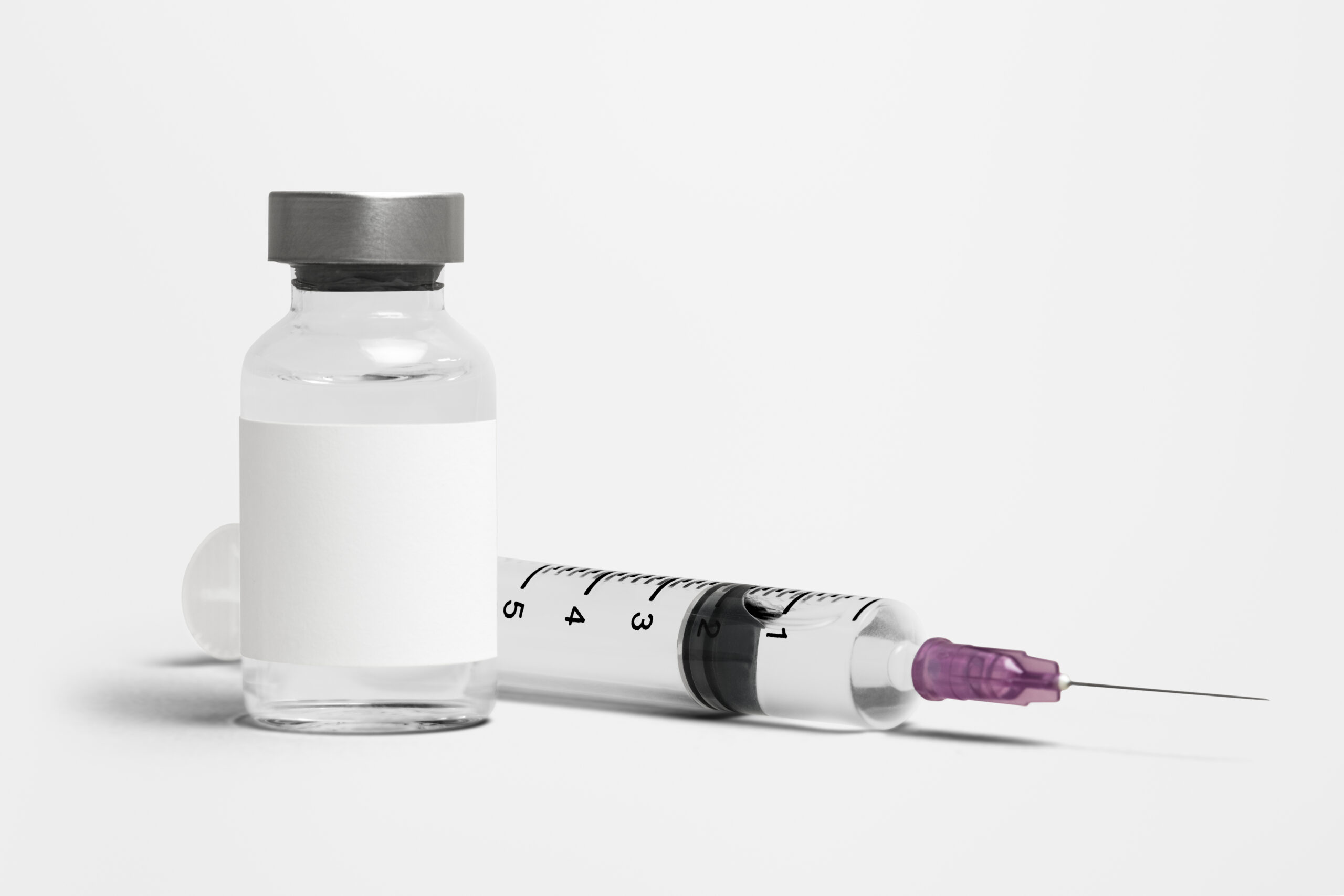 Blank white label on injection bottle glass vial with syringe Blank white label on injection bottle glass vial with syringe