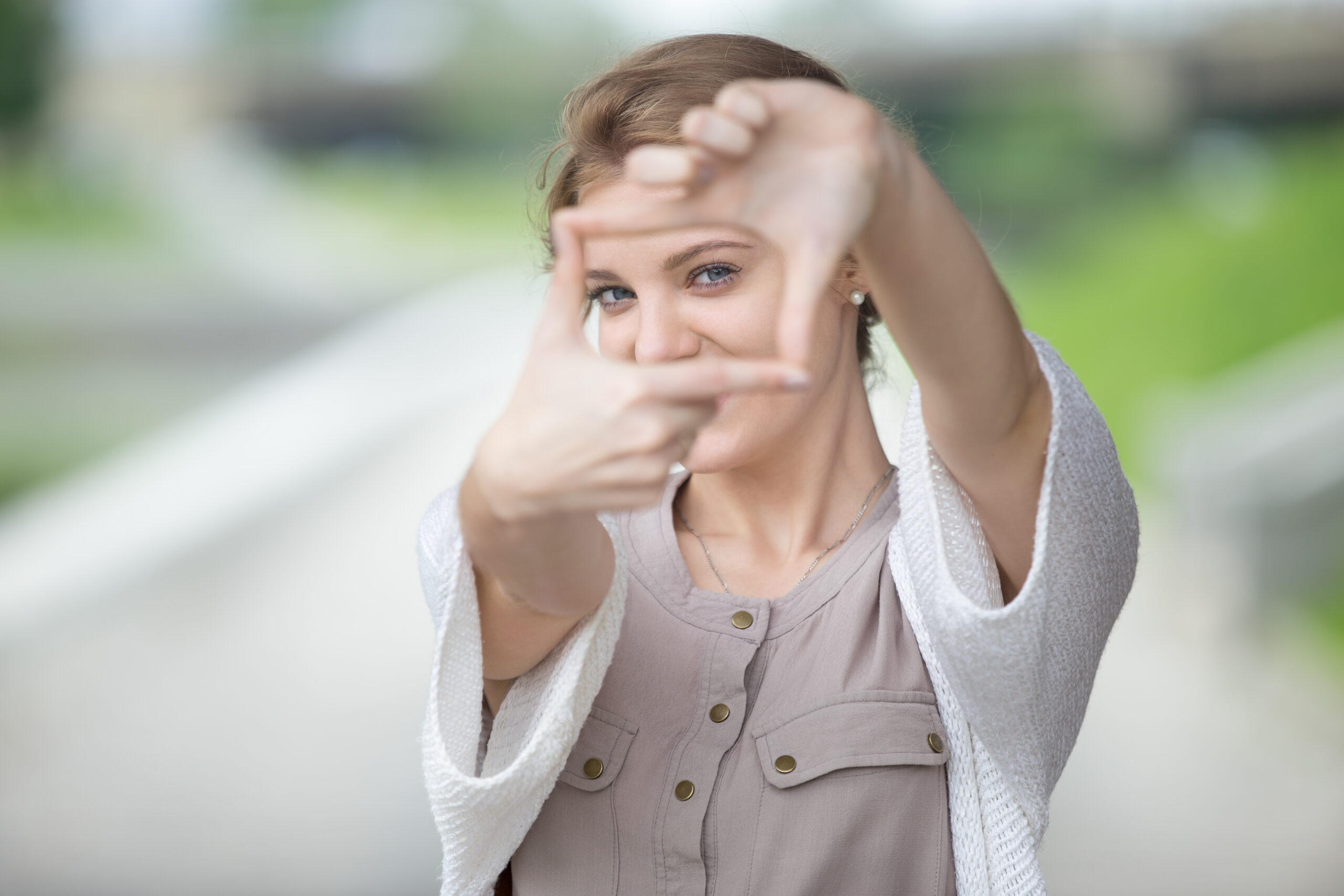 Portrait of playful woman using hands to make a frame Portrait of playful woman using hands to make a frame