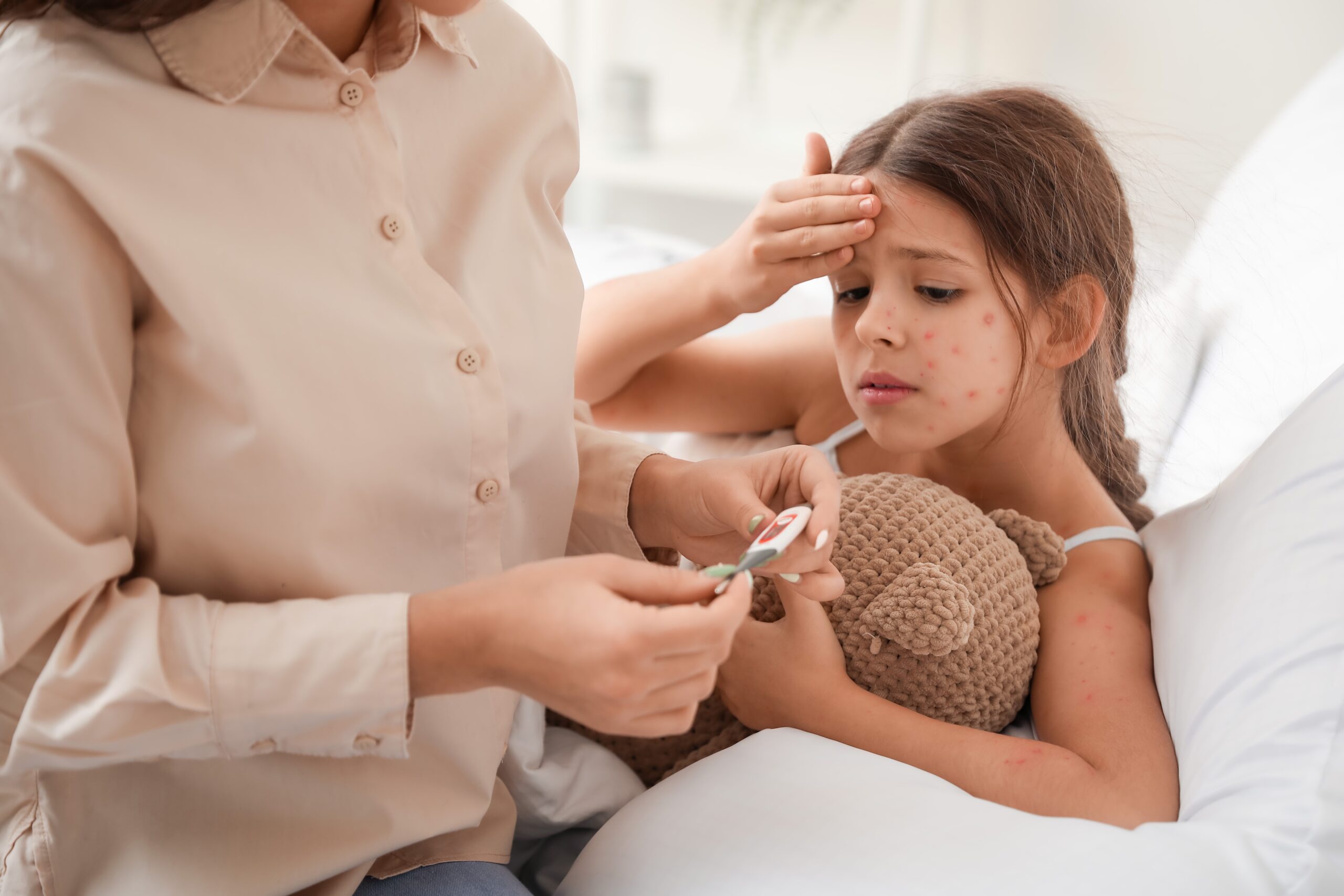 Woman,Measuring,Temperature,Of,Her,Little,Girl,Ill,With,Chickenpox Woman,Measuring,Temperature,Of,Her,Little,Girl,Ill,With,Chickenpox