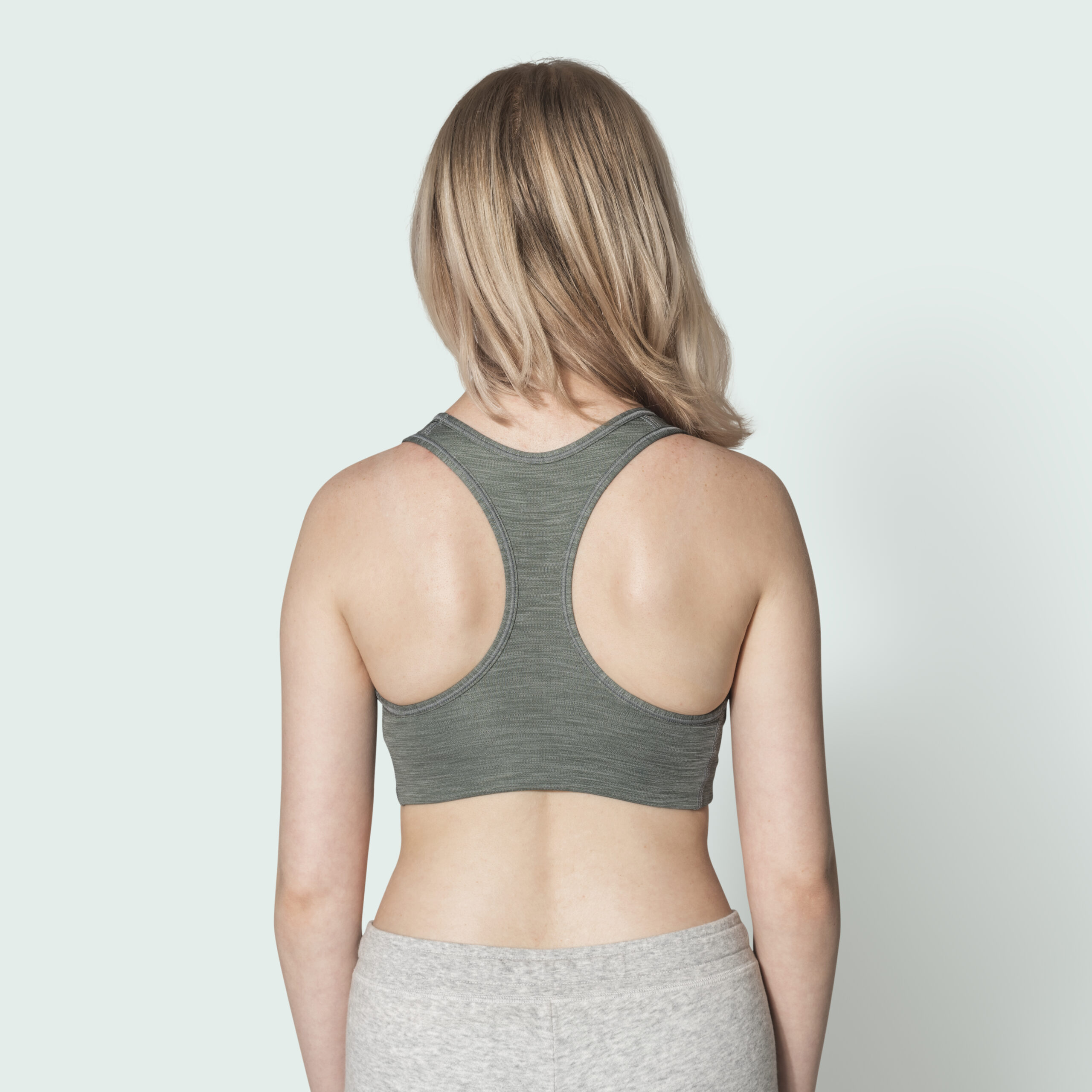 Blonde girl in gray sports bra for activewear photoshoot Blonde girl in gray sports bra for activewear photoshoot