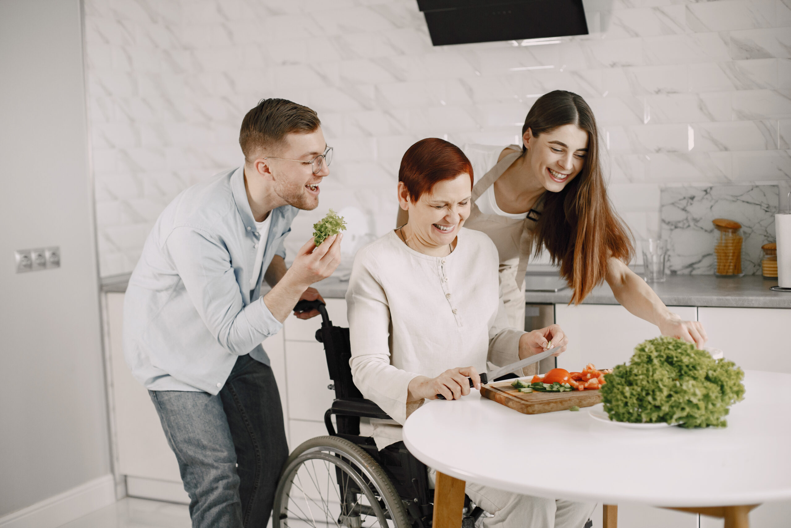 Mature disabled woman cutting vegetables in the kitchen Mature disabled woman cutting vegetables in the kitchen
