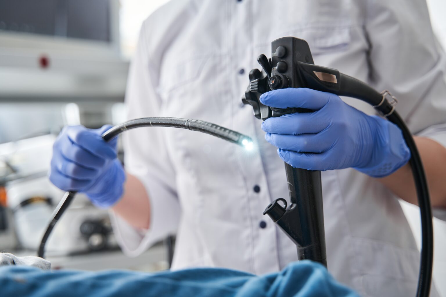 Doctor,Holding,Endoscope,During,Gastroscopy,In,Hand,While,Little,Girl