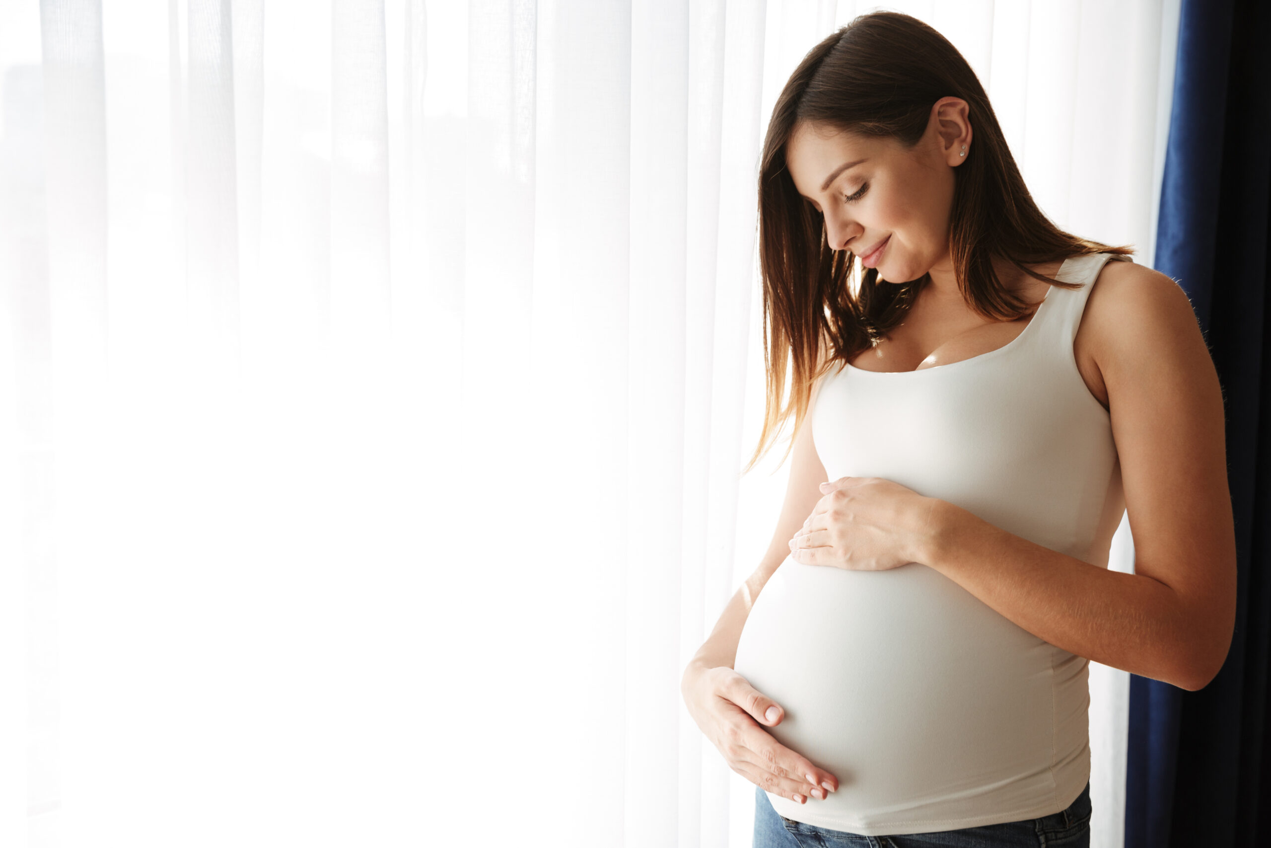 Portrait of a happy pregnant woman touching her belly Portrait of a happy pregnant woman touching her belly