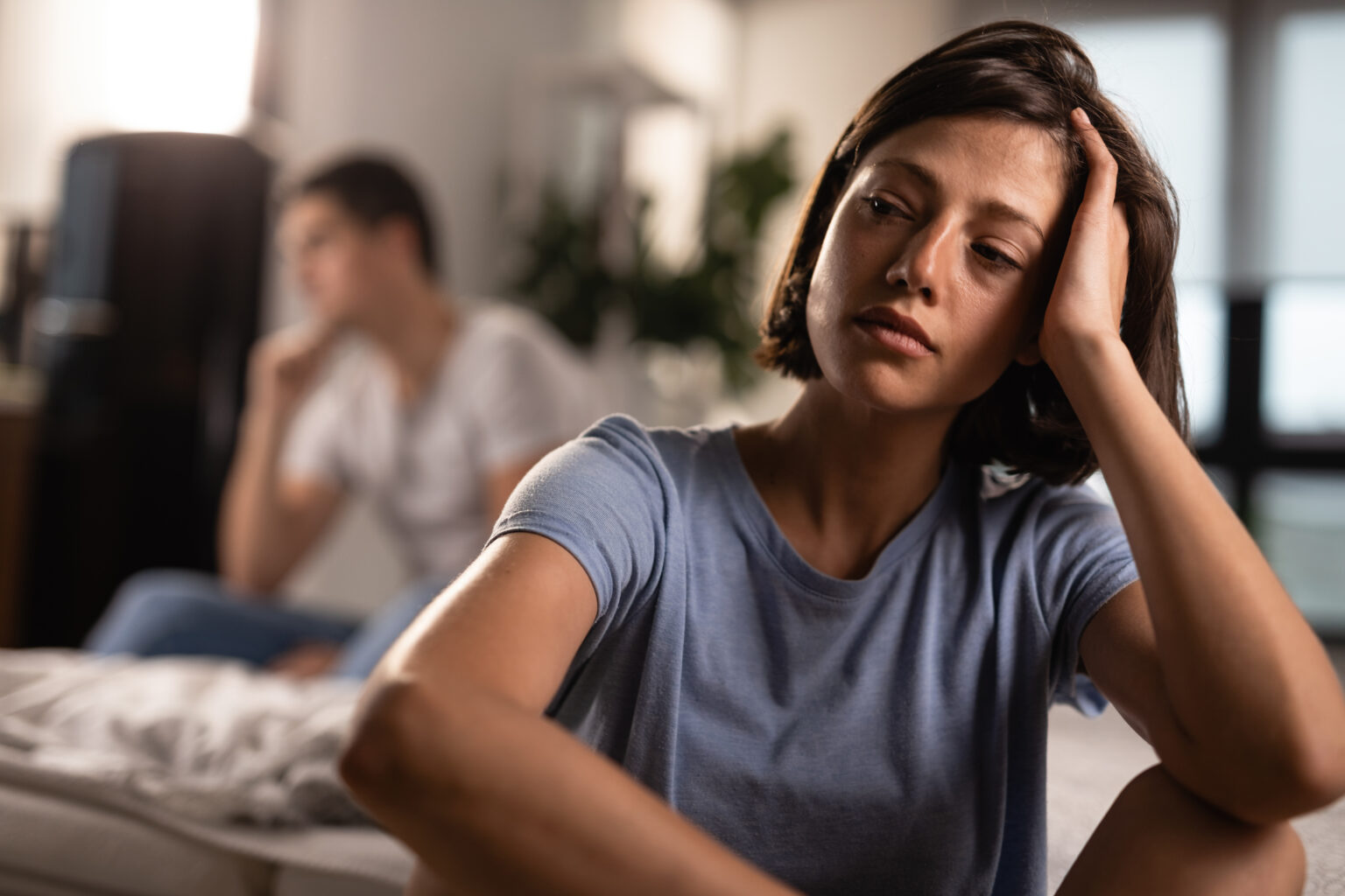 Young sad woman thinking about relationship difficulties she has with her boyfriend. Young sad woman thinking about relationship difficulties she has with her boyfriend.