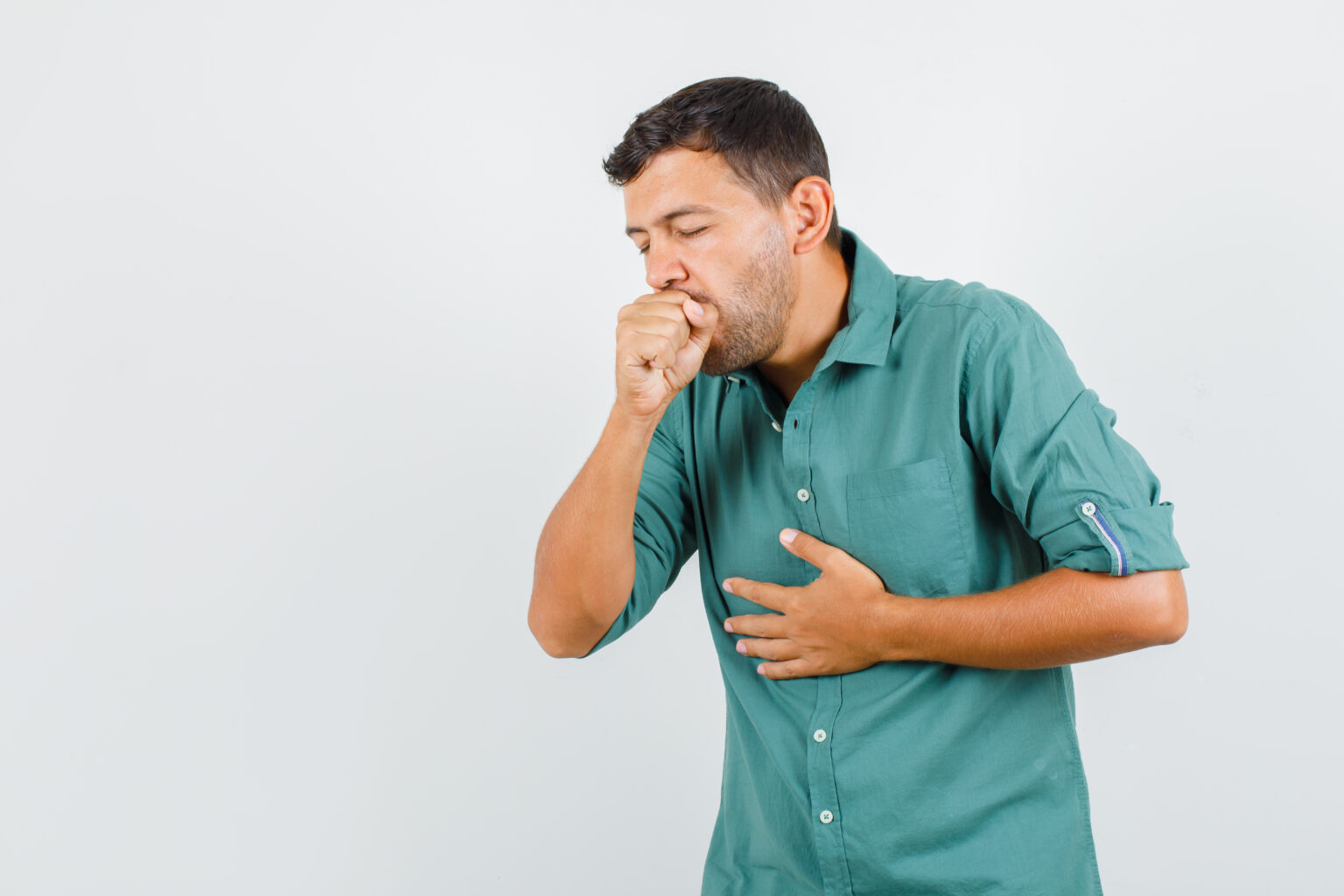 Young man suffering from cough in shirt and looking ill. front view.