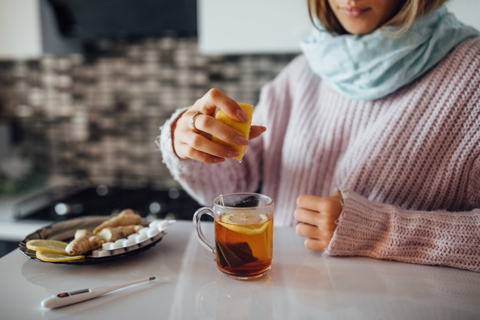 Close up photo, female hands squeezing lemon to her tea. Close up photo, female hands squeezing lemon to her tea.