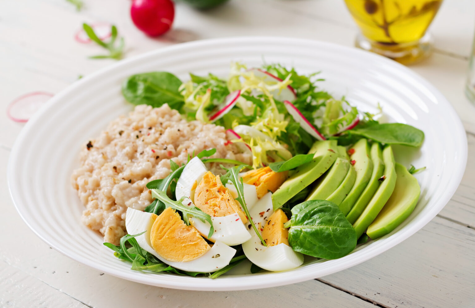 Healthy breakfast. Dietary menu. Oatmeal porridge and avocado salad and eggs. Healthy breakfast. Dietary menu. Oatmeal porridge and avocado salad and eggs.