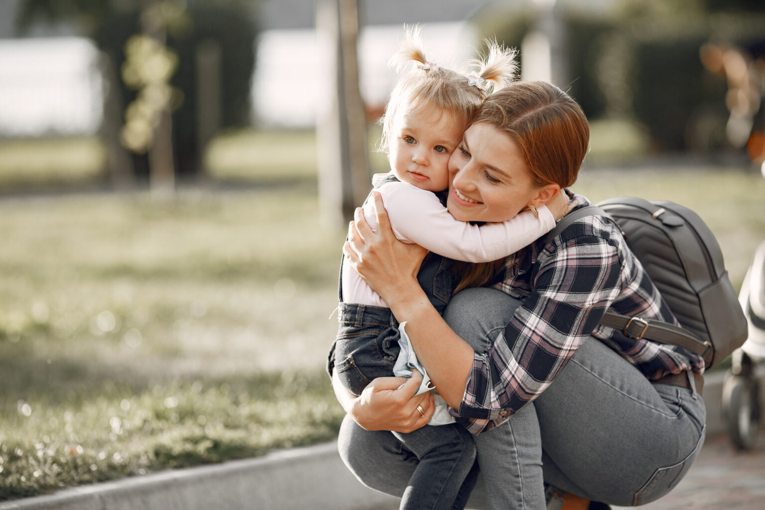 Mom and her little daughter playing in a park Mom and her little daughter playing in a park
