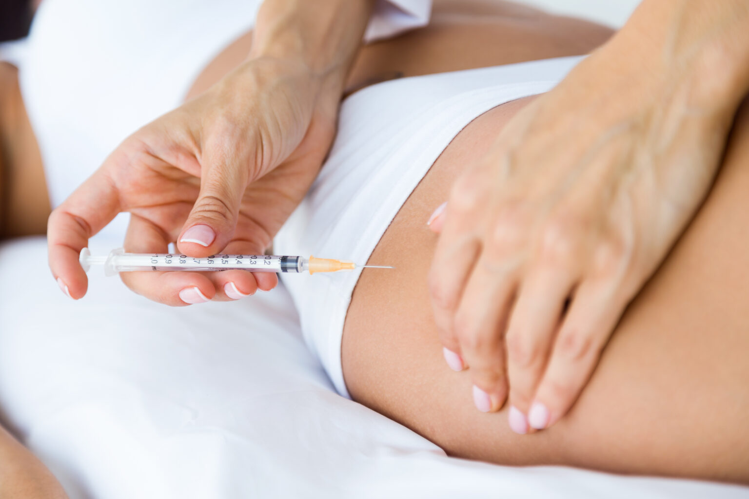 Surgeon making injection into female body. Liposuction concept. Surgeon making injection into female body. Liposuction concept.