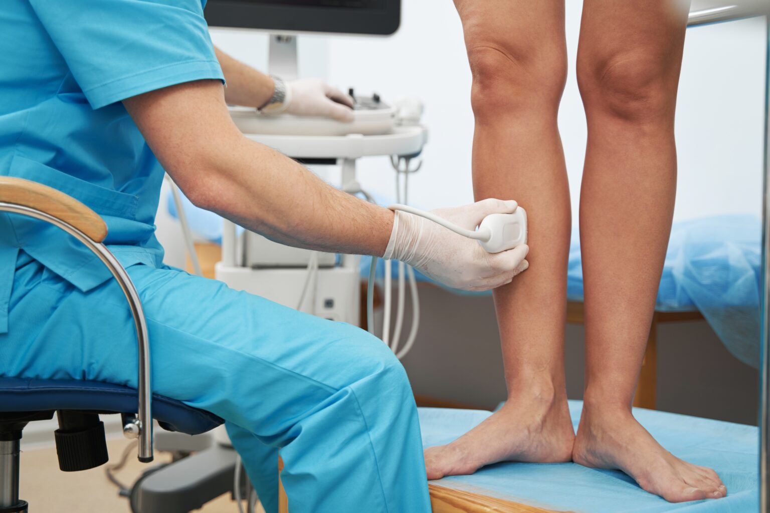 Phlebologist,Examining,The,Condition,Of,Leg,Veins,With,An,Ultrasound Phlebologist,Examining,The,Condition,Of,Leg,Veins,With,An,Ultrasound