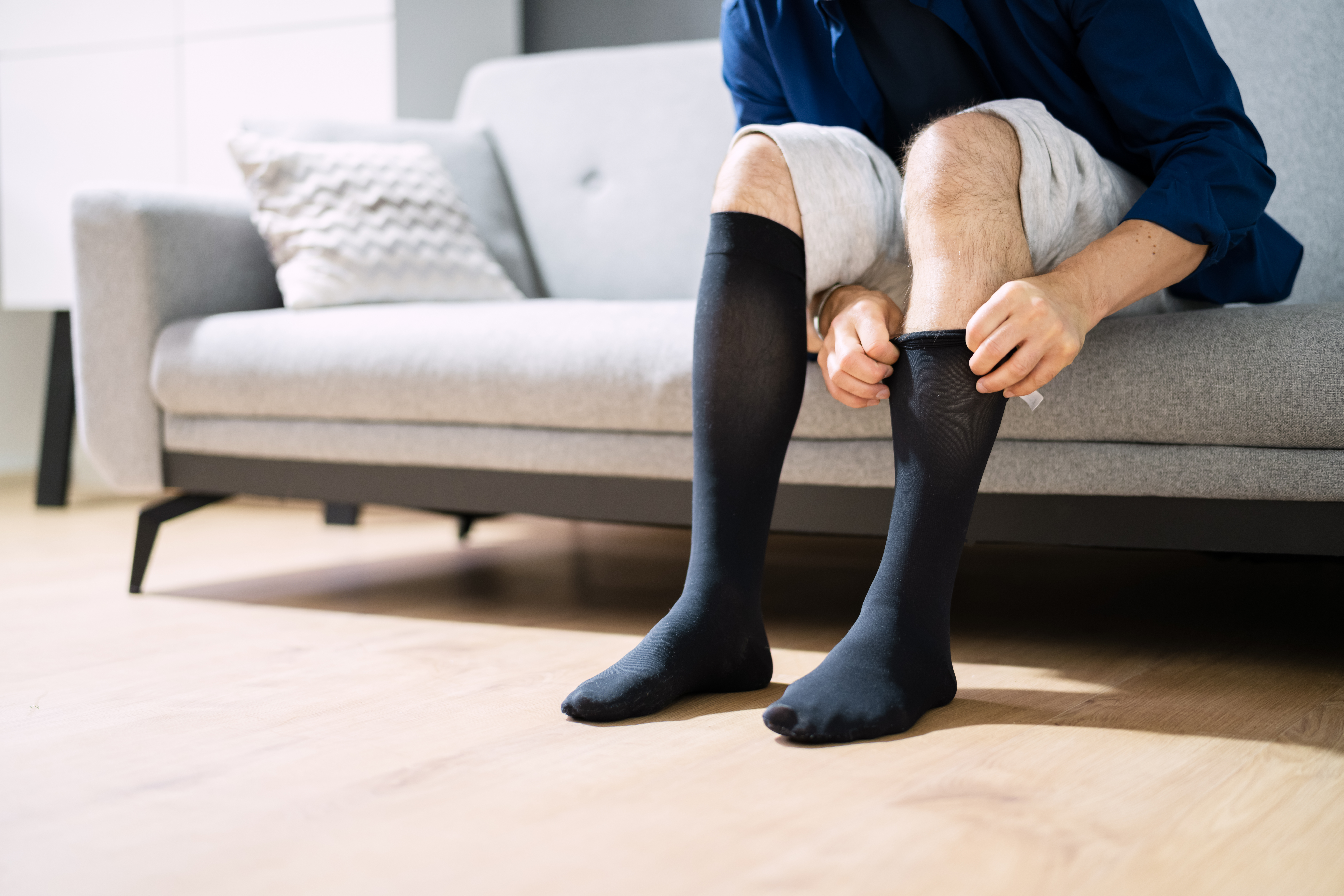 Man,Putting,On,Medical,Compression,Stockings,On,Legs Man,Putting,On,Medical,Compression,Stockings,On,Legs