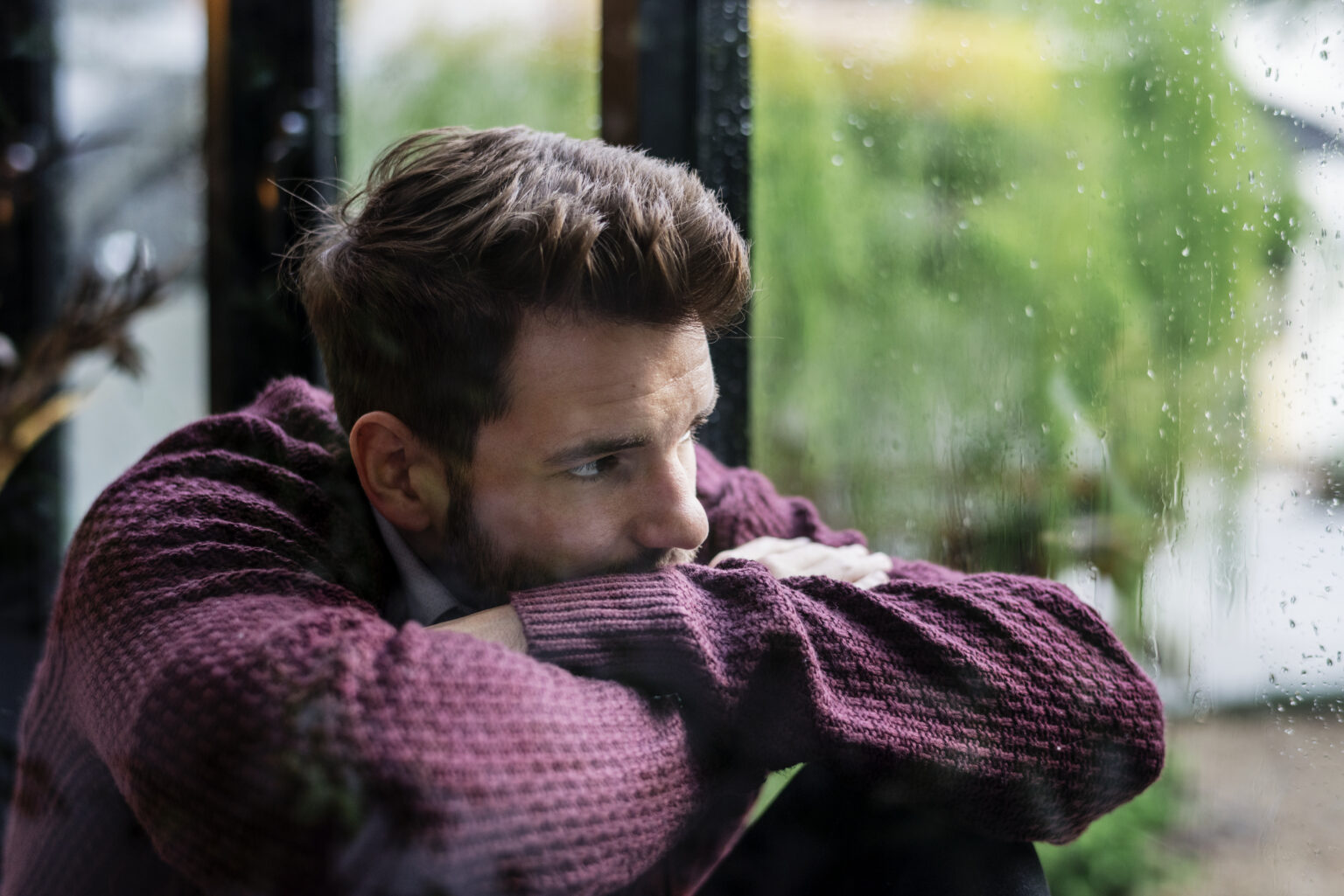Thoughtful man looking out the window Thoughtful man looking out the window
