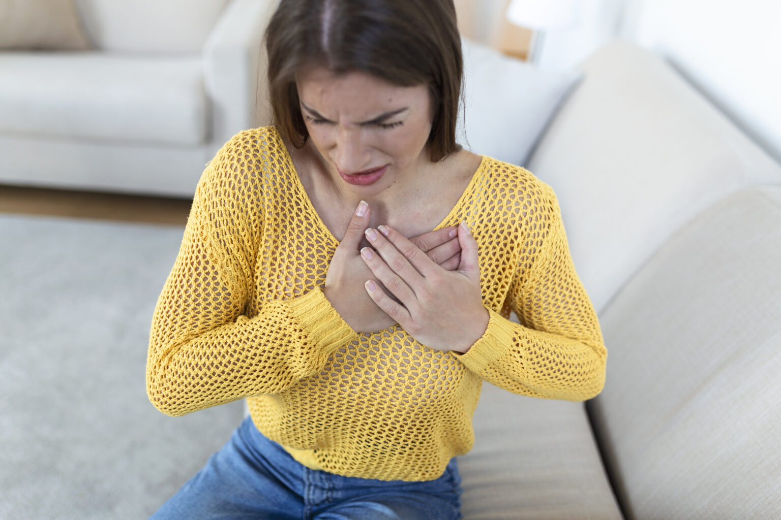 Young woman having chestpain,Acute pain, possible heart attack.Effect of stress and unhealthy lifestyle concept. Young woman having chestpain,Acute pain, possible heart attack.Effect of stress and unhealthy lifestyle concept.