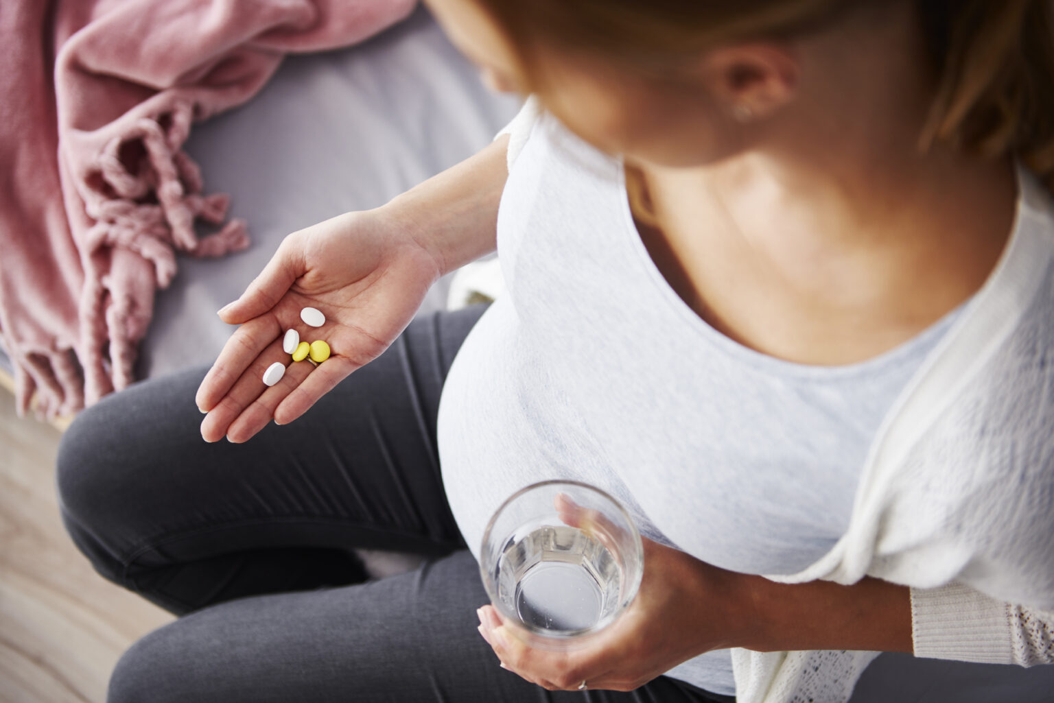 Young pregnant woman taking medicine Young pregnant woman taking medicine