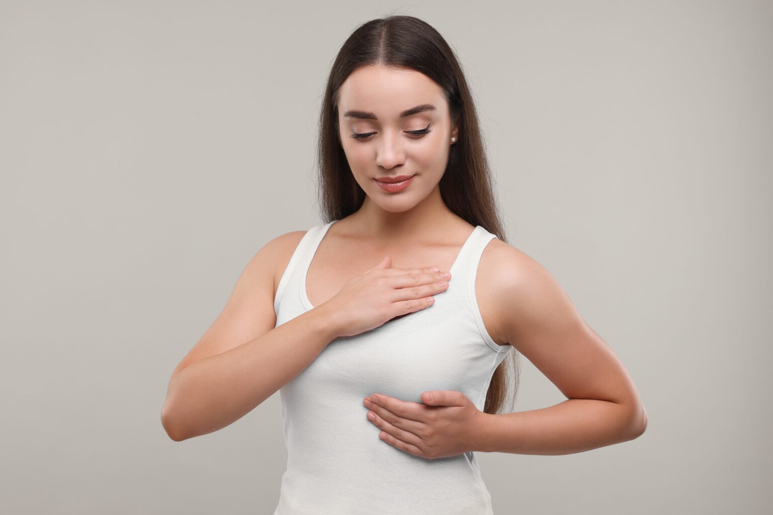 Beautiful,Young,Woman,Doing,Breast,Self-examination,On,Light,Grey,Background Beautiful,Young,Woman,Doing,Breast,Self-examination,On,Light,Grey,Background