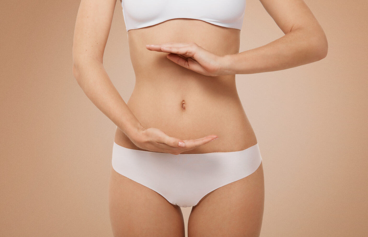 Woman showing sign bio balance on her stomach isolated