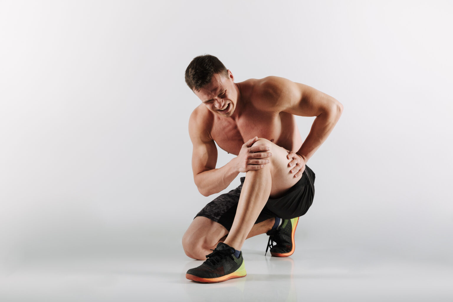 Displeased young sportsman have painful feelings in leg. Displeased young sportsman have painful feelings in leg.