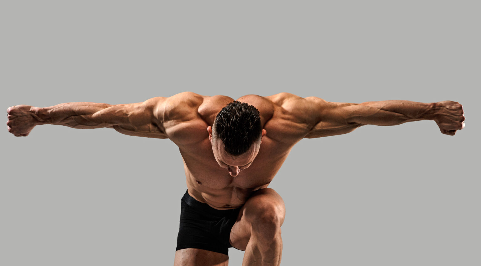 Bodybuilder on grey background Bodybuilder on grey background