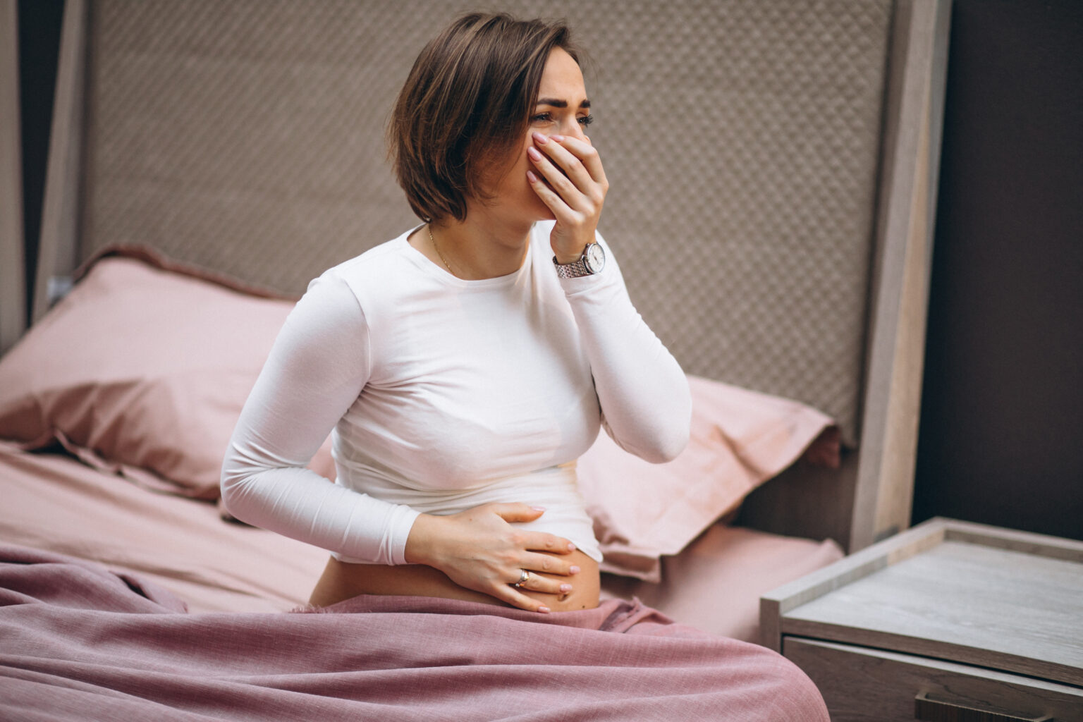 Young pregnant woman having toxicosis in first trimester Young pregnant woman having toxicosis in first trimester