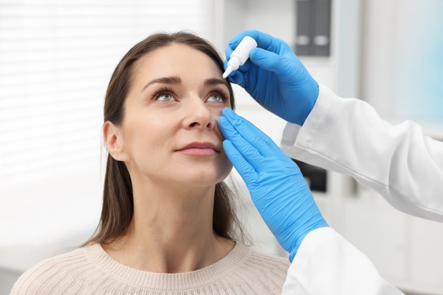 Doctor,Applying,Medical,Drops,Into,Woman’s,Eye,Indoors Doctor,Applying,Medical,Drops,Into,Woman’s,Eye,Indoors