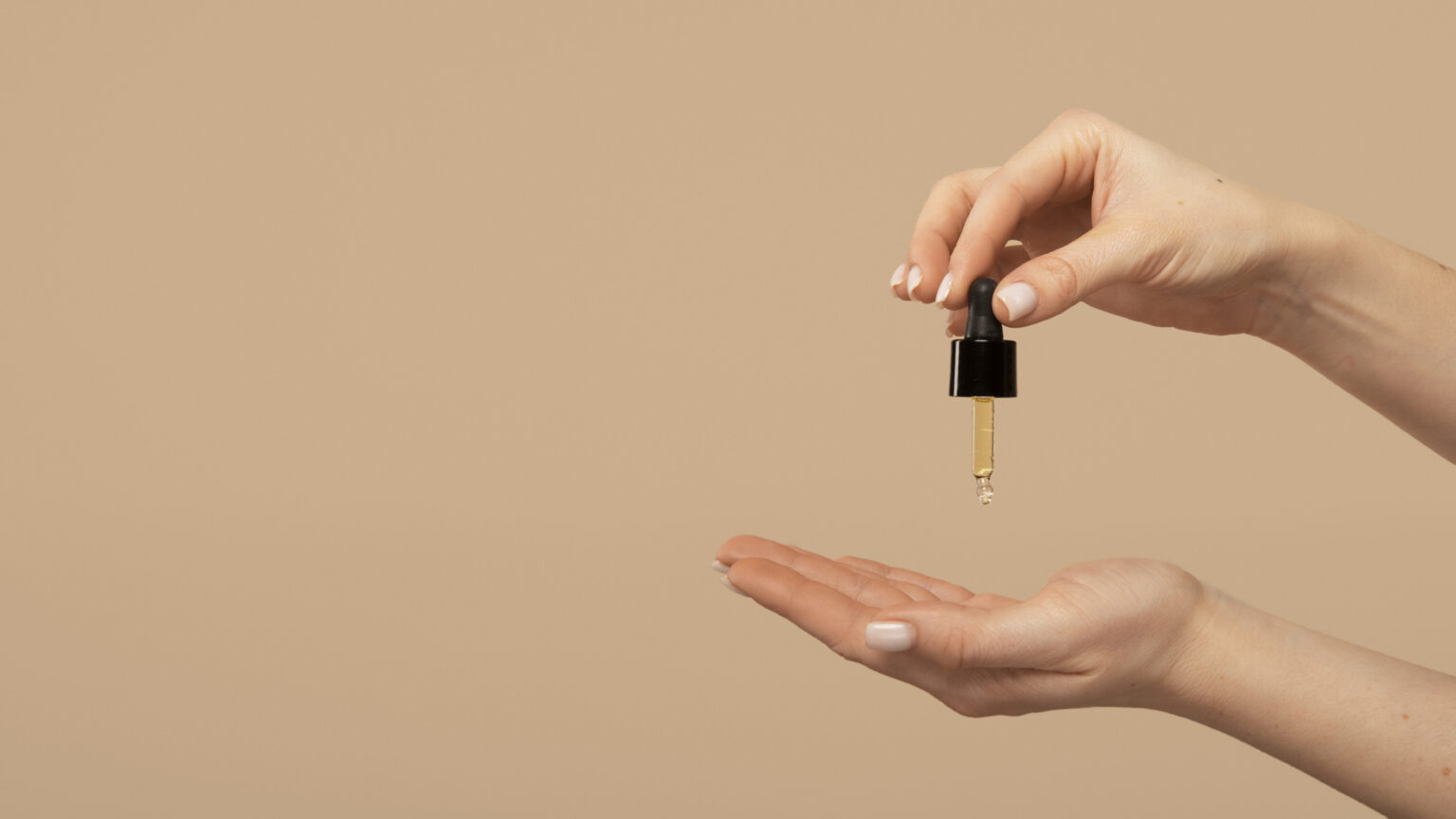 close-up-hands-holding-serum