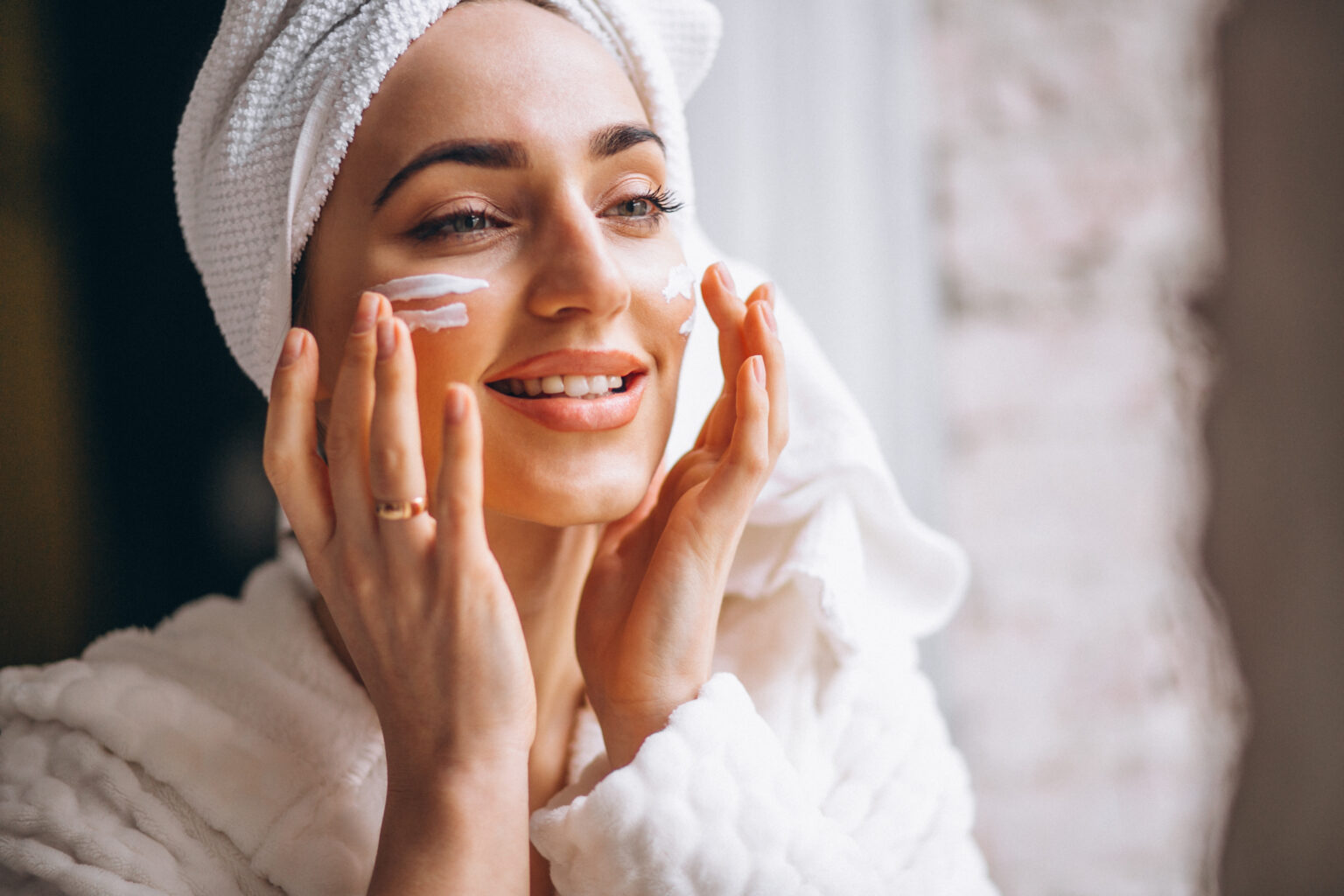 Woman applying face cream Woman applying face cream