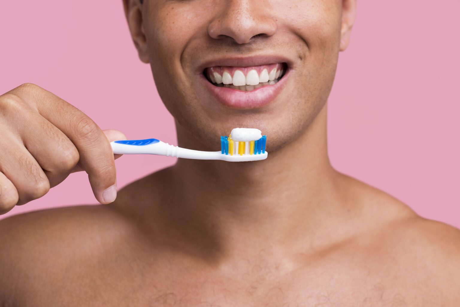 front-view-smiley-man-holding-toothbrush-with-toothpaste front-view-smiley-man-holding-toothbrush-with-toothpaste