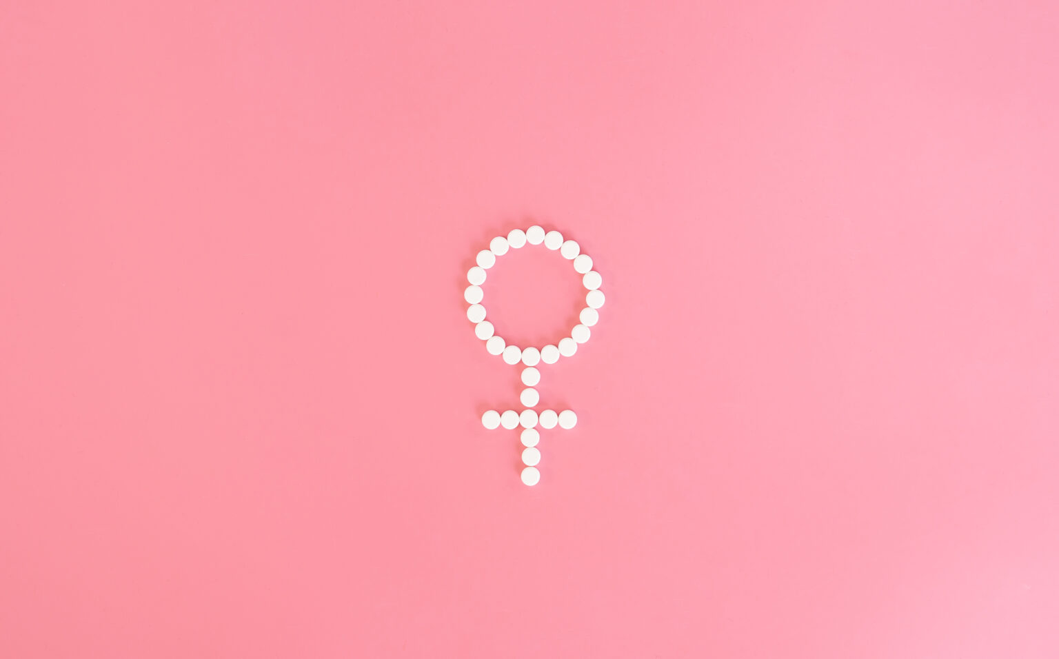 Pills on a pink background, flat lay, women’s health. Pills on a pink background, flat lay, women’s health.