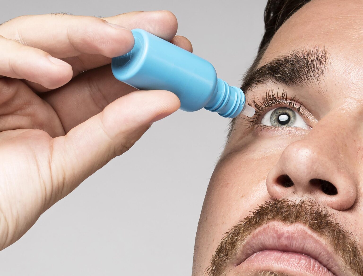 man-using-eye-drops-close-up man-using-eye-drops-close-up