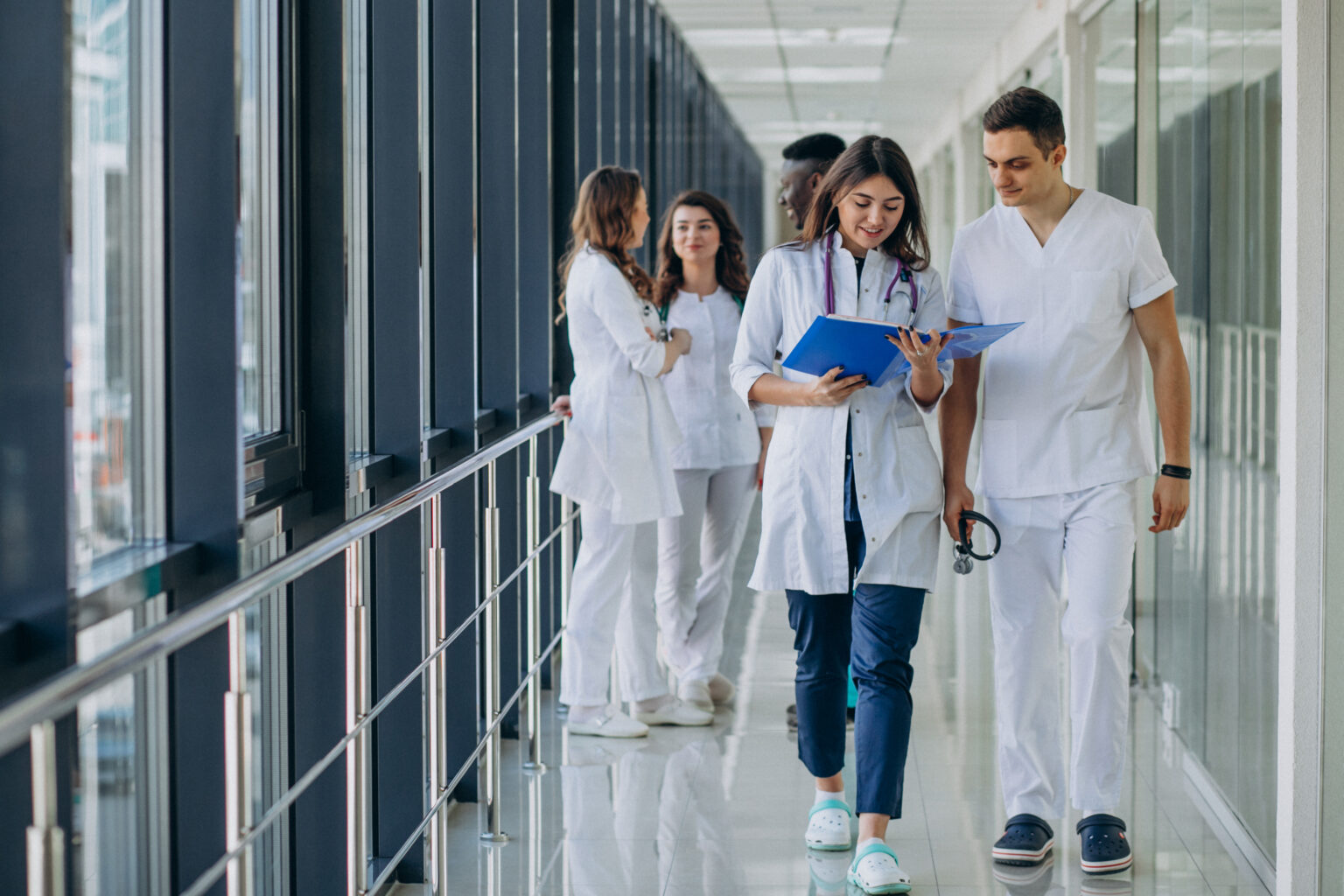 team-young-specialist-doctors-standing-corridor-hospital team-young-specialist-doctors-standing-corridor-hospital