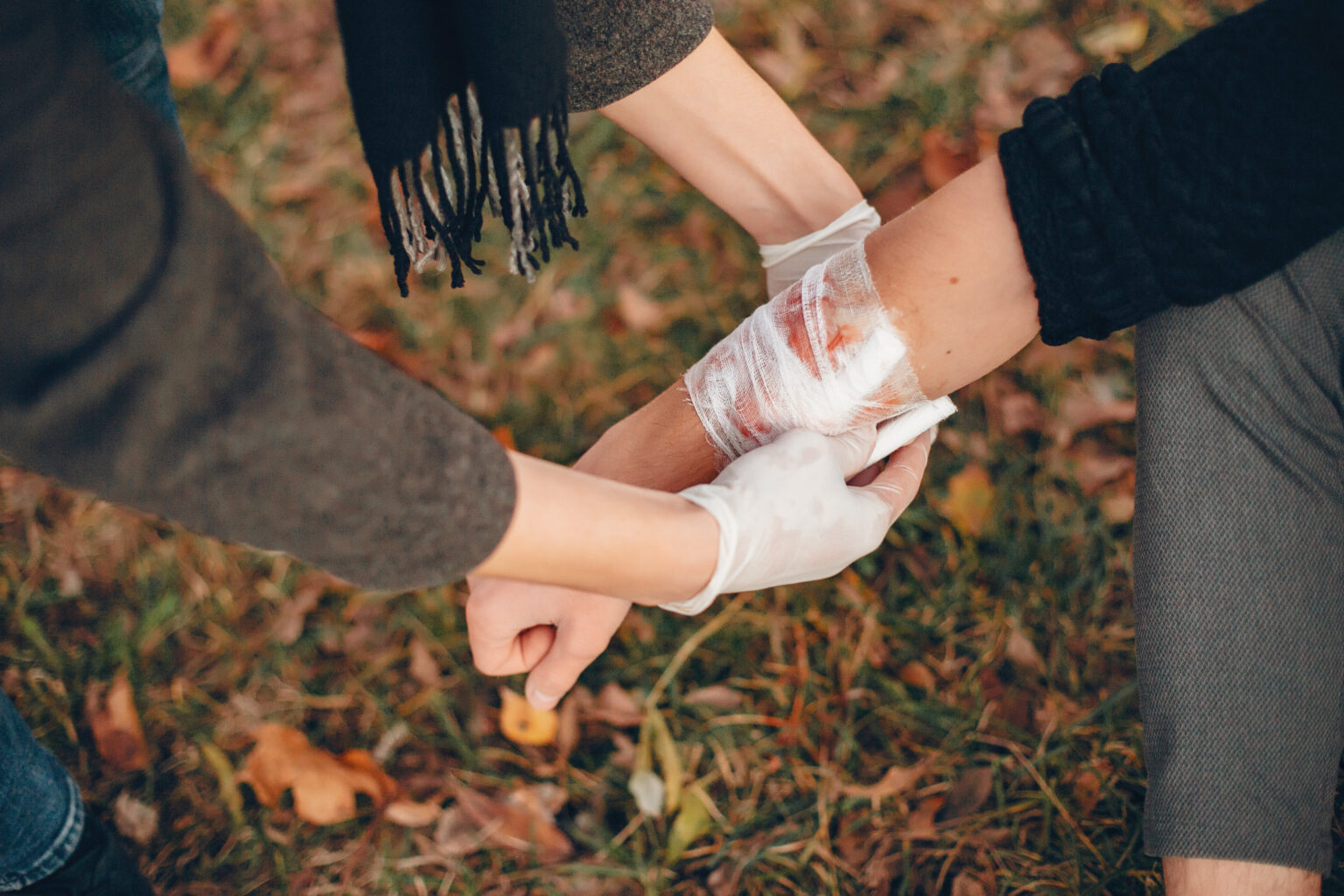 Guy bandages his friend’s hand Guy bandages his friend’s hand