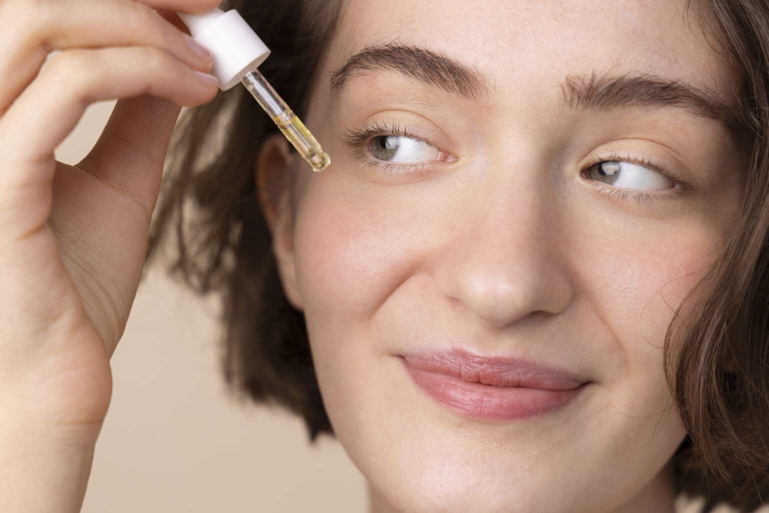 close-up-smiley-girl-using-face-serum close-up-smiley-girl-using-face-serum